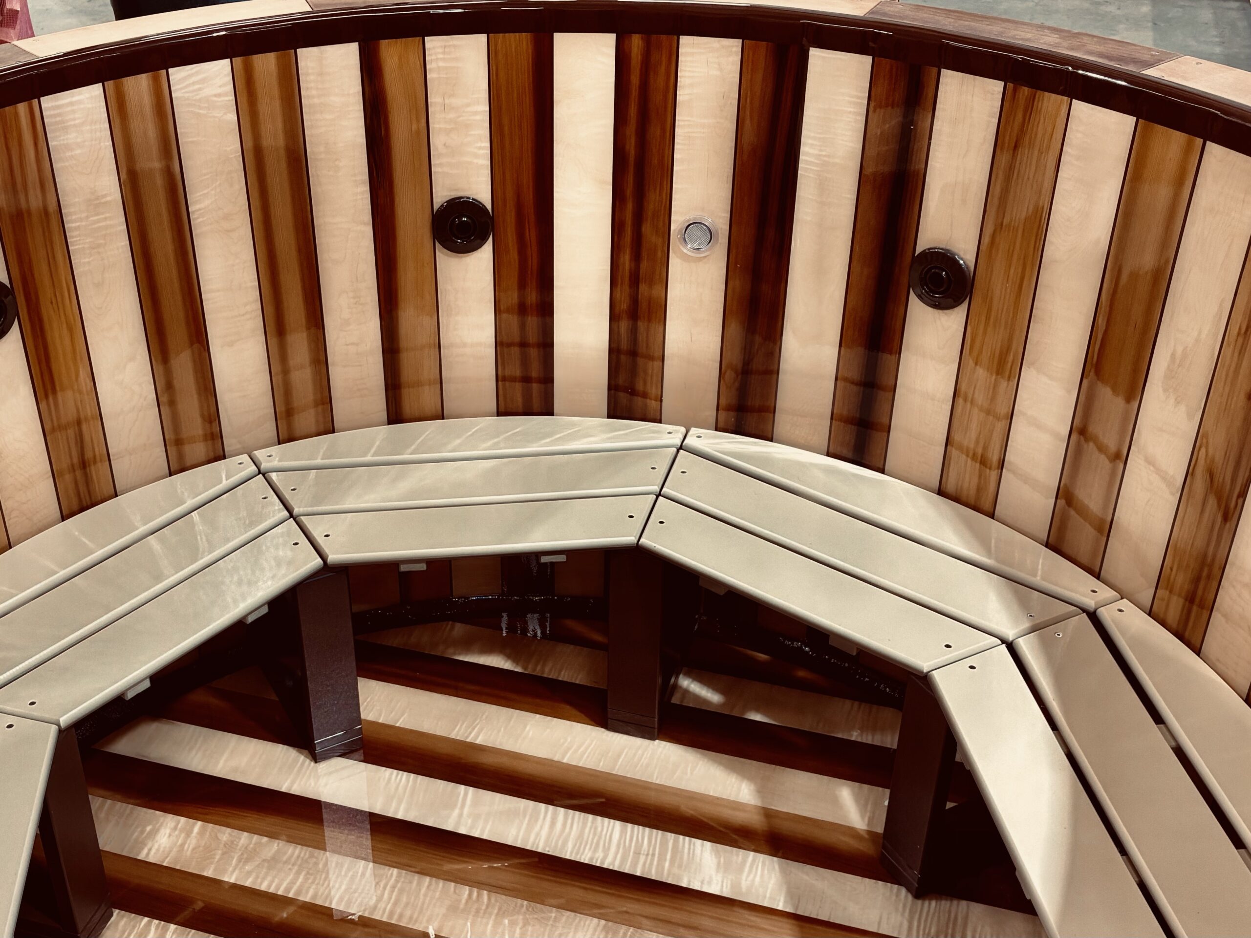 Inside of a cold-molded hot tub showcasing the wood captures in what looks like glass. 